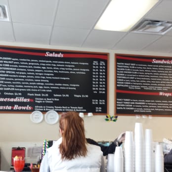 Fancy Pantry - a woman standing in front of a menu - Delis Near Me - Atlanta, Georgia Fancy Pantry - a woman standing in front of a menu - Delis Near Me - Atlanta, Georgia
