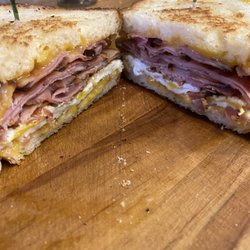 Freshly sliced Ham, egg and cheese breakfast sandwich.