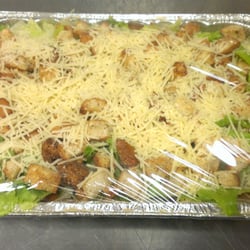 Broadway Pizza and Grill - Our freshly made caesar salad for catering, topped with homemade croutons and shredded parmesean cheese