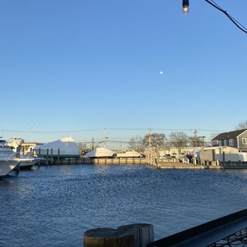 Elliot's - a boat in the water near a dock - Seafood Near Me - Freeport, New York