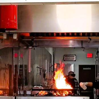 Cuarto de Kilo Mesquite Burgers - View of the grill from the dining area. - Burgers Near Me - Helotes, Texas Cuarto de Kilo Mesquite Burgers - View of the grill from the dining area. - Burgers Near Me - Helotes, Texas