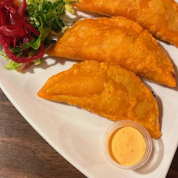 Rico Sabor - a white plate with three empanadas and a salad - Cuban Near Me - Las Vegas, Nevada Rico Sabor - a white plate with three empanadas and a salad - Cuban Near Me - Las Vegas, Nevada