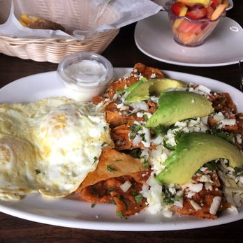 Fiesta Cafe - Chilaquiles w/ red sauce, 2 over medium eggs and a side of fruit - Breakfast & Brunch Near Me - Milwaukee, Wisconsin