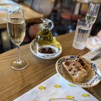 Lemonica - Complimentary happy hour champagne and yummy bread with olives. - Wine Bars Near Me - Hollywood, Florida