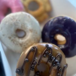 Colorado Donuts - Chocolate Caramel Crunch Donut, Ube Cake Donuts, Horchata Donut, Strawberry Vegan Donut, and Plain Cake Donut
