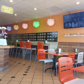 Yo Sushi - A look on the inside. There are pictures of the sushi with their prices and a TV with kpop playing. Two TV's total - Sushi Bars Near Me - Albany, California