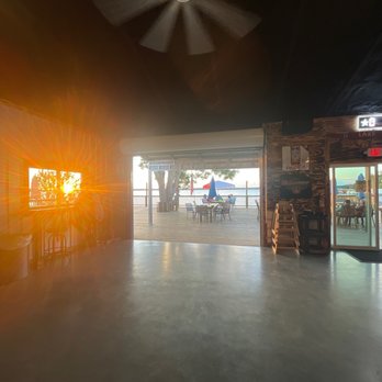 The Wet Deck - View of the deck and sunset from inside. - American Near Me - Livingston, Texas The Wet Deck - View of the deck and sunset from inside. - American Near Me - Livingston, Texas