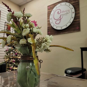 Gathering Grounds Coffee - a jar of flowers on a table - Coffee & Tea Near Me - Huntsville, Alabama
