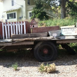an old red truck with a wooden fence an old red truck with a wooden fence
