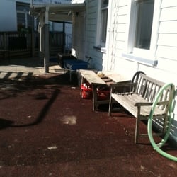 Northcote Point Community Creche - Bench seats in the padded play area with sandpit in the background