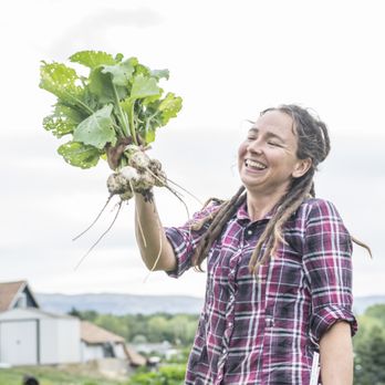 Radix Farm - a woman holding a bunch of radishes - CSA Near Me - Malaga, Washington Radix Farm - a woman holding a bunch of radishes - CSA Near Me - Malaga, Washington