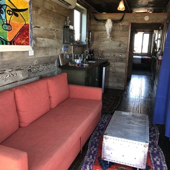 Flophouze Shipping Container Hotel - Living room with sofa bed - Hotels Near Me - Round Top, Texas