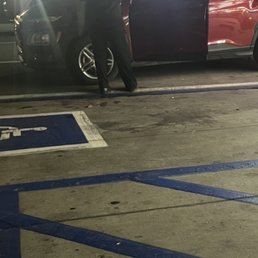 a police officer standing next to a red car a police officer standing next to a red car