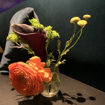 Apéro - a vase of flowers on a table - Bars Near Me - Washington, DC, District of Columbia