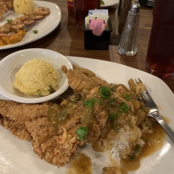 Bon Temps Grill - Fried catfish mon dieu with jalapeño grits sitting on rice. - Cajun/Creole Near Me - Lafayette, Louisiana Bon Temps Grill - Fried catfish mon dieu with jalapeño grits sitting on rice. - Cajun/Creole Near Me - Lafayette, Louisiana