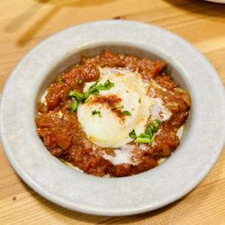 Aviv Hummus Bar - Traditional shakshuka! Wow! A poached egg basking in a hearty tomato pepper stew!!! So so delicious!