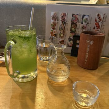 Zakkushi on Queen West - Mojito and sake-cylinder in back - Japanese Near Me - Toronto, Ontario Zakkushi on Queen West - Mojito and sake-cylinder in back - Japanese Near Me - Toronto, Ontario