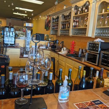Vintner's Canton Winery - a bar with wine glasses and bottles - Wineries Near Me - Canton, Michigan