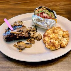 Hoss's Steak & Sea House - Filet mignon with mushrooms, baked potato, and crab cake