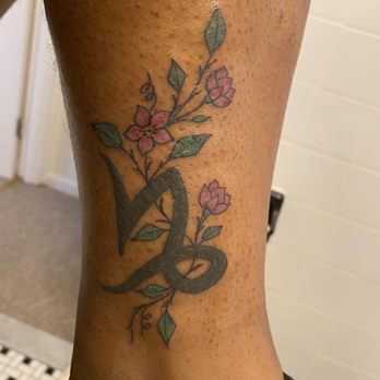 Solid Gold Tattoo - Capricorn Zodiac Tattoo with Flowers. - Tattoo Near Me - Elmont, New York