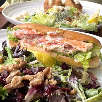 The Freight Shed - Lobster roll... filled with lettuce, decorated with lobster meat on top - Canadian (New) Near Me - Baddeck, Nova Scotia