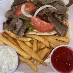 Garden of Eden Grill - Gyro pita sandwich and fries with tzatziki sauce and ketchup on the side.