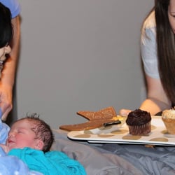 Fort Worth Birthing & Wellness Center - Nurse Midwife, Carla, singing happy birthday to my newborn shortly after birth and letting my older son blow out the candles.