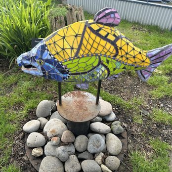 Siuslaw Riverside - a colorful fish sculpture in a garden - Delis Near Me - Florence, Oregon Siuslaw Riverside - a colorful fish sculpture in a garden - Delis Near Me - Florence, Oregon