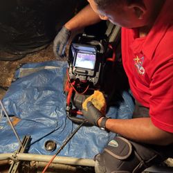 XM Plumbing - Xavier explaining the condition of the drain pipe using his camera equipment.