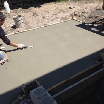 Quality Restoration - a man laying a concrete slab - General Contractors Near Me - Windsor, Ontario Quality Restoration - a man laying a concrete slab - General Contractors Near Me - Windsor, Ontario