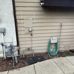 Back flow preventer located underneath electrical panel.