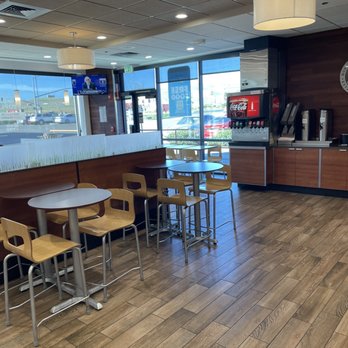 Wendy's - A fast-food restaurant interior featuring tables, chairs, a beverage station, and large windows with a view outside. - Fast Food Near Me - Patterson, California