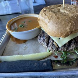 Mushroom Swiss burger and side of tomato soup. Mushroom Swiss burger and side of tomato soup.