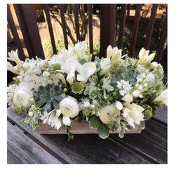 A sympathy arrangement, tailored for the occasion. I appreciate the florist's attention to detail, artistic liberty, and special touch.