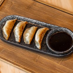 Donkari - Pan-fried chicken gyoza with a tangy dipping sauce. Crispy outside, juicy inside -- perfect as a snack or side.