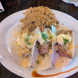 Beer breaded fish tacos with bean salsa mixed cheese and spicy mayo.