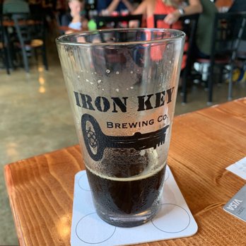 Iron Key Brewing - a pint glass on a coaster - Breweries Near Me - Columbus, North Carolina Iron Key Brewing - a pint glass on a coaster - Breweries Near Me - Columbus, North Carolina