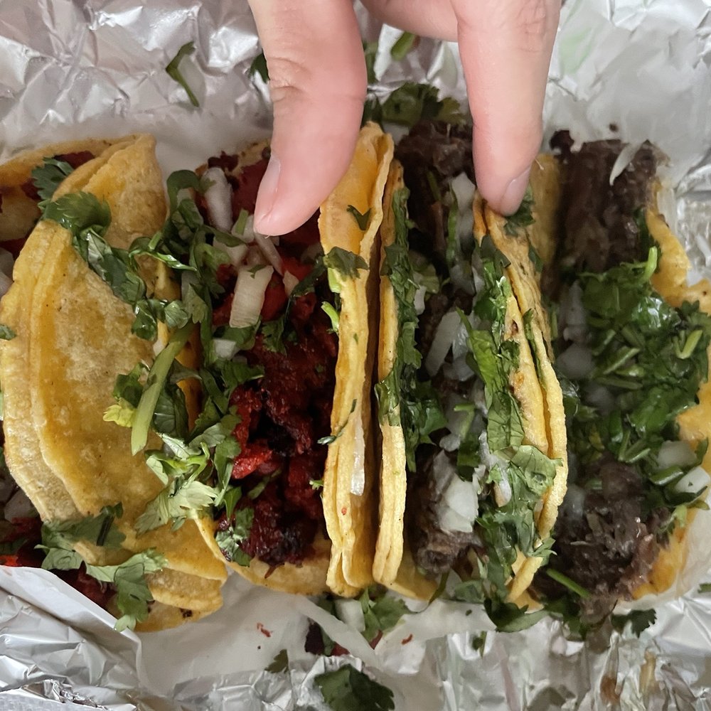 Taqueria Brisa - a hand reaching for a taco - Mexican Near Me - Houston, Texas Taqueria Brisa - a hand reaching for a taco - Mexican Near Me - Houston, Texas