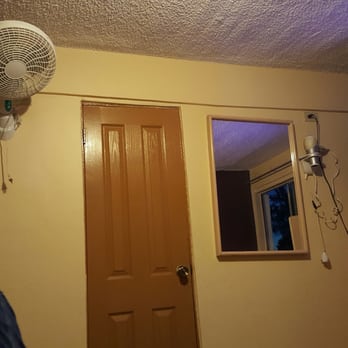 Hotel San Diego - Fan and hairdryer nailed to the wall. Door to bathroom - Hotels Near Me - Tijuana, BCN