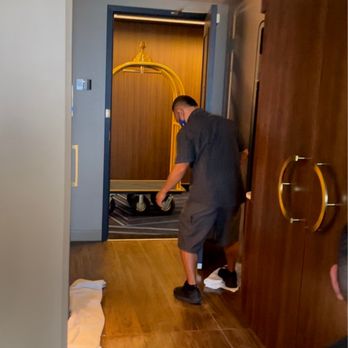 Circa - The bell man kindly cleaning the puddle of water on the floor while the roof still leaks - Casinos Near Me - Las Vegas, Nevada
