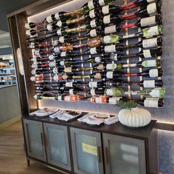 Six & Sky Rooftop Grille - The display case full of wine bottles. - Steakhouses Near Me - Roanoke, Virginia