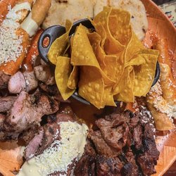 Paseo Catracho - Plato catracho, pork, carne asada, taquitos, pupusas, stuffed plantain and anafre with chips, beans and cheese.