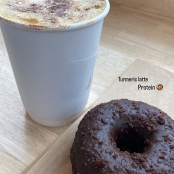 Trident Coffee - Turmeric latte and double chocolate protein donut - Coffee & Tea Near Me - San Diego, California Trident Coffee - Turmeric latte and double chocolate protein donut - Coffee & Tea Near Me - San Diego, California