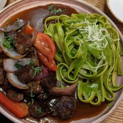 Mil Roast Sports & Bar - Lomo saltado with pesto pasta