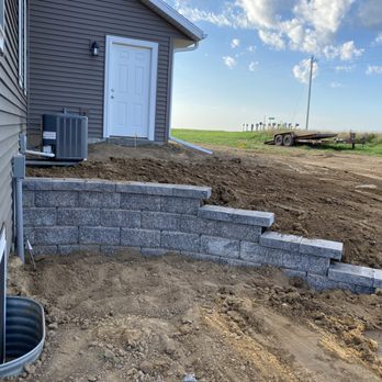 Rock Solid landscaping - a view of the back of a house - Landscaping Near Me