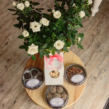 Tesora - a vase of white roses and cookies on a table - Desserts Near Me - Buellton, California
