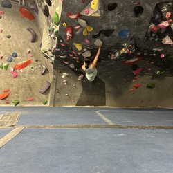 Progression Climbing - Person climbing in the overhang section of progression climbing gym