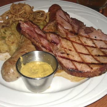 Kurt's Euro Bistro - Schwabian Platter (bratwurst, bauernwurst, ans pork chop with sauerkraut and German potato salad) - Modern European Near Me - Duluth, Georgia