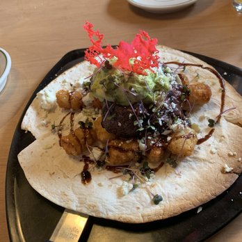 The Roasthouse Pub - Roasted tenderloin "tatchos" with tater tots, homemade guacamole, and fresh blueberry salsa - Pubs Near Me - Frederick, Maryland