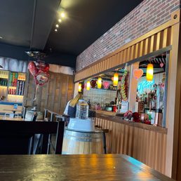 a bar with a wooden table and chairs